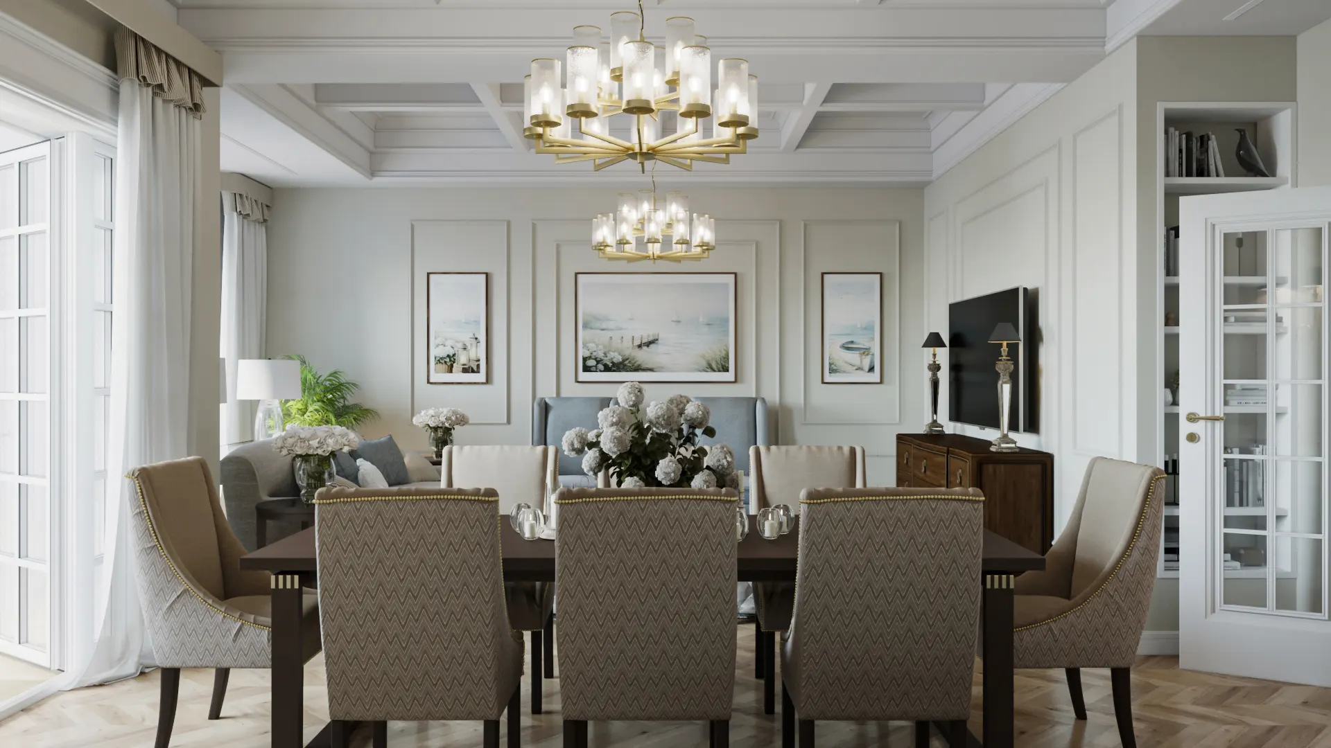 A sophisticated open-concept dining and living room featuring elegant chevron-patterned chairs, tiered gold chandeliers, and classic wall moldings.