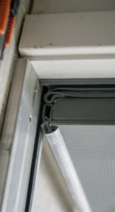 Close-up of a heavy-duty acoustic rubber perimeter seal installed on a door frame to block airborne sound transmission and isolate noise.