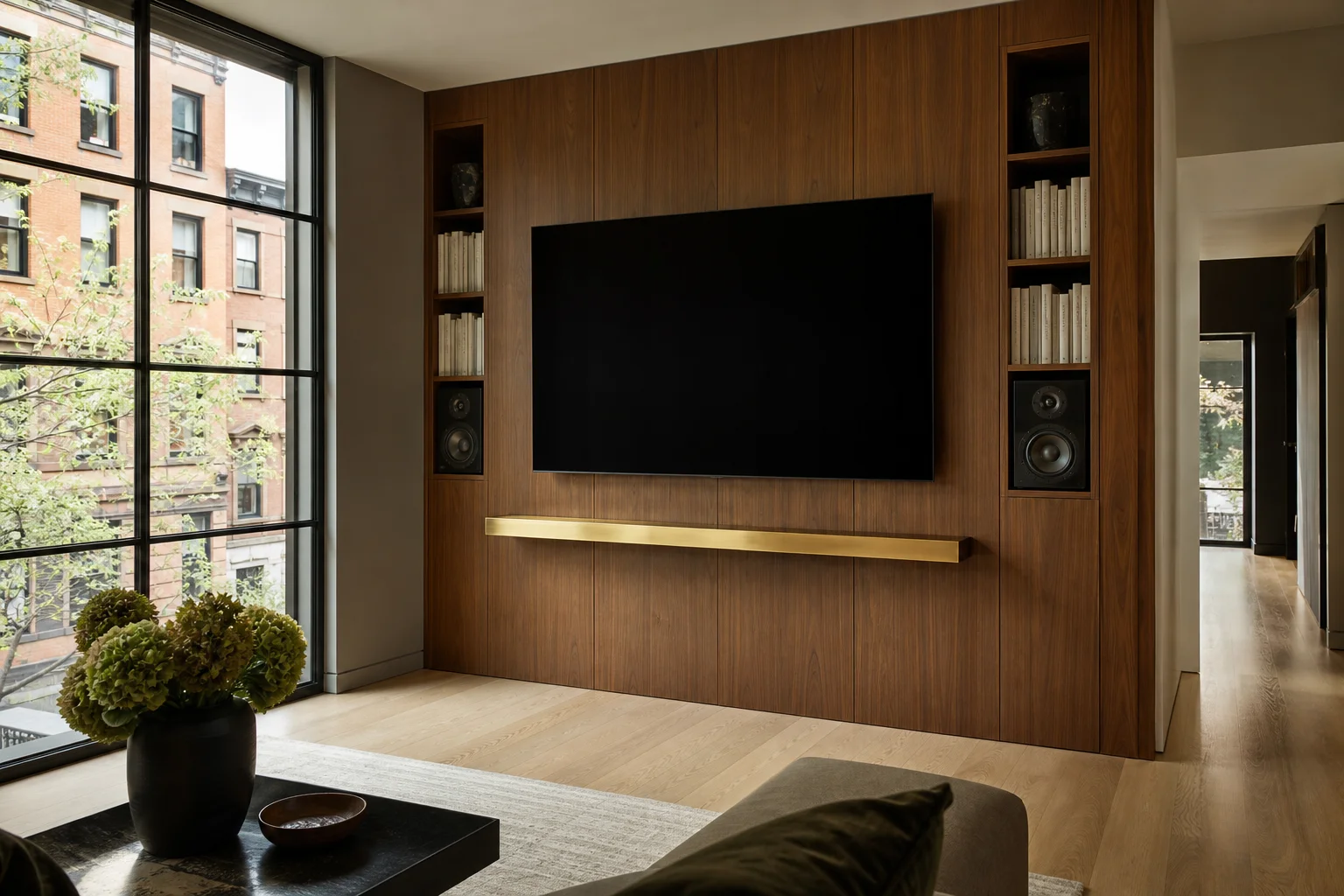 Wall-mounted TV on a walnut paneled media wall with flanking cabinetry and a floating shelf