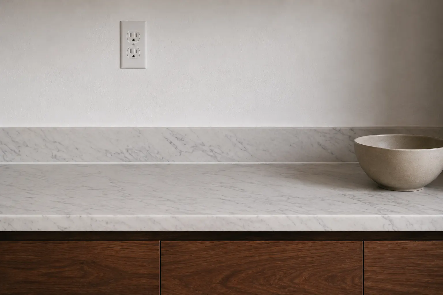 Kitchen outlet mounted a few inches above a marble backsplash, well inside the 20 inch limit above the countertop